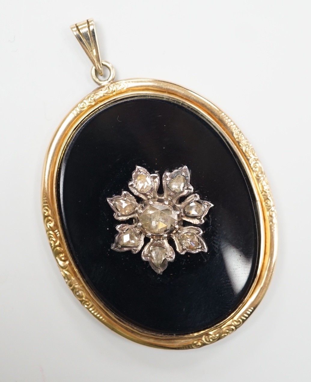 A Victorian yellow metal mounted, rose cut diamond set black onyx oval pendant, overall 56mm, gross weight 12.9 grams.